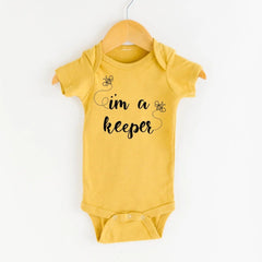 I'm a Keeper Mustard Onesie by Nature Supply Company